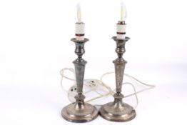 Pair of silverplated candlestick type table lamps with circular bases.