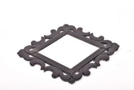 A contemporary Venetian style diamond shaped wall mirror with black glass frame (af).