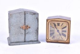 A small brass travel clock with shagreen effect case.