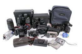 A collection of cameras, two pair of binoculars and a JVC video camera.