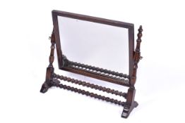A Victorian bobbin turned dressing table mirror. Turned and faceted colums with double stretcher.