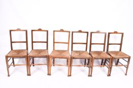 Six early 20th century oak chair in the arts and crafts manner.