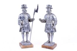 Pair of pewter figures on marble plinths modelled as Beefeater Yeoman Warder.