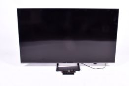 A Samsung UE55DU8500K 55Inch Television and two remote controllers.