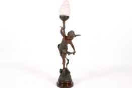 A spelter 'angel' figure holding a torch table lamp.