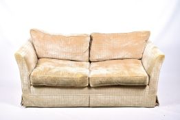 A contemporary two-seater low back sofa with stripped upholstery.