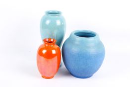 Three pottery vases by Ruskin, Royal Doulton and Royal Lancastrian.