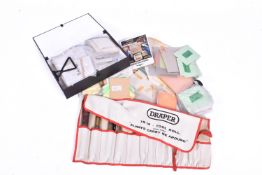 A gold leaf kit along with a large amount of leaf in books.