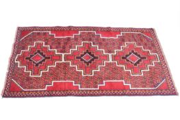 A modern geometric red and blue rug Persian style rug.