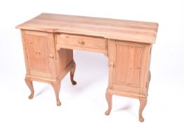 A modern pine knee hole dressing table or desk.