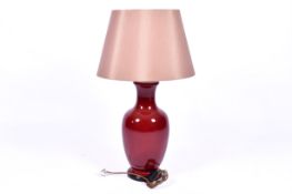 A contemporary Chinese sang de boeuf style vase table lamp. Raised on a turned wooden base.