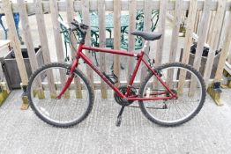 A red Raleigh Avalanche 15 speed mens bicycle.