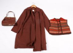 A knitted brown waistcoat, brown duster coat and a brown leather vintage handbag.