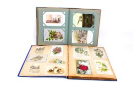 An album of vintage postcards and another.