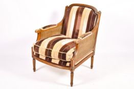A French Bergere mahogany style armchair with stripped brown upholstery.