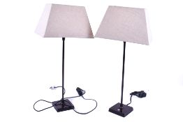 A pair of contemporary Parex table lamps. Raised on square metal bases.