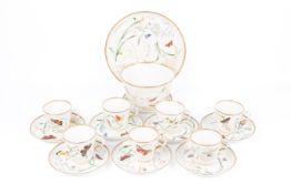 A collection of seven tea cups hand painted with butterflies and foliage.
