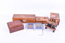 A group of assorted wooden collectables. Including four boxes and a fishing reel.