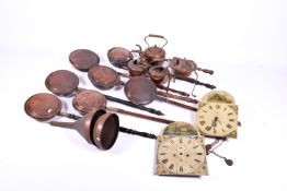 A quantity of copper items including seven warming pans, tea pots and funnels. Plus two clock faces.