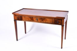 A 20th century Georgian style oak writing table or desk with three drawers.