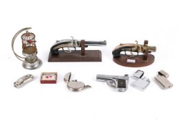 A collection of 20th Century novelty lighters. Including muskets, birdcage, pistol and pocket watch.