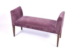 A contemporary upholstered window seat. Raised on square tapering supports.