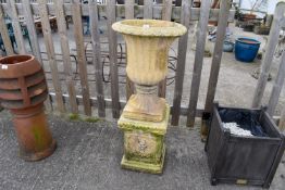 A large reconstituted two-piece stone urn and plinth. Total H107cm, the urn H83m.