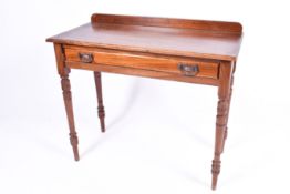 A 20th Century mahogany writing table. Gallery back with single frieze drawer sat on turned legs.