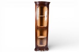 A 20th century mahogany corner cabinet. Glass fronted with fabric lined interior shelves.