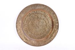 A very large circular embossed brass charger. Having embossed geometric designs.