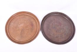 Two circular worked metal trays bought in Bangladesh.
