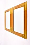 A pair of contemporary bevel edge wall mirrors, framed.