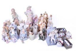 A large quantity of bisque porcelain figures and egg jewellery boxes.