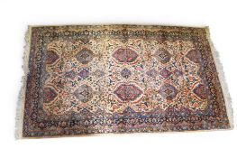 A 19th Century Persian cream and blue ground rug. With blue and red decorative patterns.