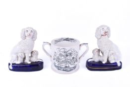 A pair of Staffordshire dogs and twin handled 'Trust In God' cider mug.