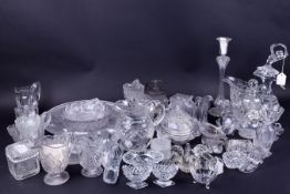 A quantity of assorted press moulded clear glass items.