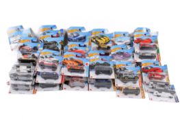 A collection of carded Hotwheels diecast model cars.