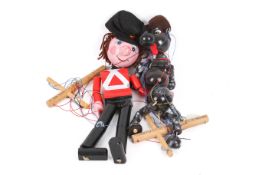 Two boxed Pelham Puppets by David Leech. One modelled as a Royal Guard, the other a dog.