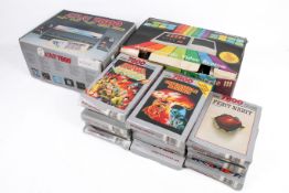 Two vintage electronic home video games consoles and a group of games.