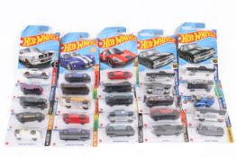 A collection of carded Hotwheels diecast model cars.