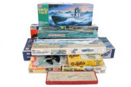 A collection of military ship and aircraft model kits.