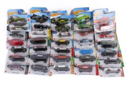 A collection of carded Hotwheels diecast model cars.