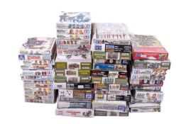 A collection of assorted plastic model maker's kits of soldiers.