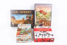 A collection of four assorted modern board games.