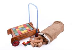 A Tri-ang walker and a set of wooden building blocks.