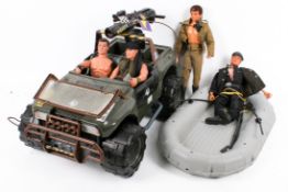 A collection of assorted vintage and modern Action Man figures with uniforms and weapons.