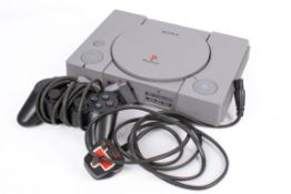 A Sony Playstation I and controller. Model SCPH-9002, Ref B3799049.