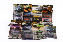 A collection of carded Hotwheels diecast model cars.