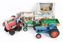 A collection of five assorted model tractors.