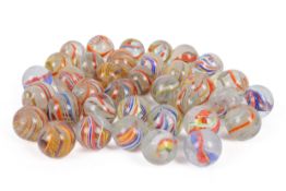 A collection of vintage glass marbles. Including onion skin examples, etc.